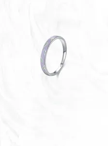 Close-up of S925 sterling silver ring featuring purple and green enamel abstract patterns