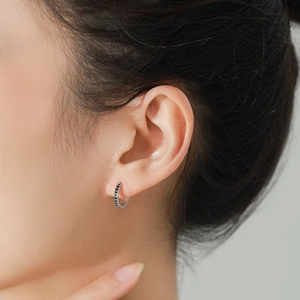 925 Sterling silver hoop earrings with black enamel arrow pattern on female model