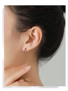 Close-up of S925 sterling silver hoop earring with black arrow pattern on model