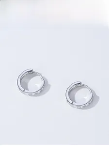Detail shot of S925 sterling silver hoop earrings with romantic LOVE engraved pattern