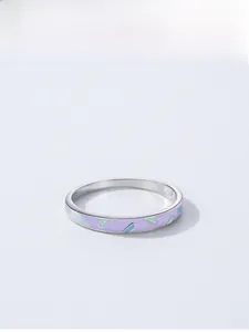 Detail of 925 silver ring with purple enamel finish and colorful diagonal stripe patterns