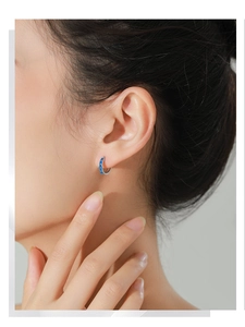 Close-up of elegant S925 silver hoop earrings with blue enamel and sparkling zircon accents