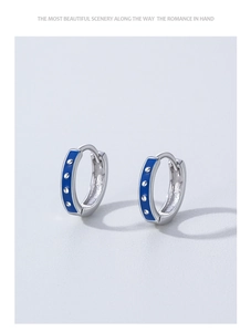 Detail of S925 silver hoop earrings with Klein blue enamel and silver stud accents