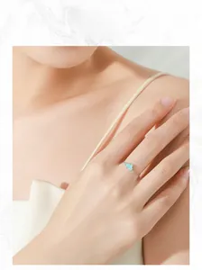 Detail of adjustable S925 silver chain ring with light blue cloud charm on finger