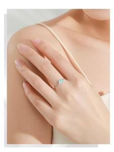 Close-up of S925 sterling silver chain ring featuring a soft blue enamel cloud charm