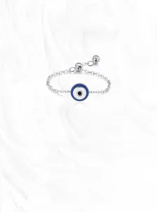 Detailed macro view of S925 sterling silver chain with blue evil eye enamel charm
