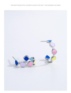 Detailed view of 925 silver C-shaped earrings with colorful drip oil enamel accents