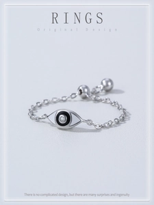 Macro detail of 925 sterling silver evil eye chain ring with crystal and enamel inlay