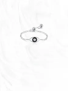 Macro detail of S925 sterling silver stamp on Evil Eye chain ring with clear gemstone