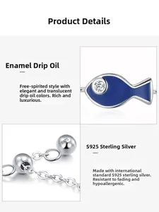 Macro detail of S925 sterling silver stamp and blue enamel fish charm on adjustable ring