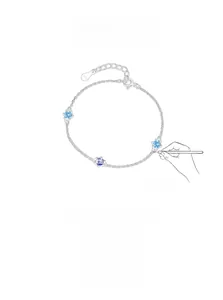 Macro detail of S925 sterling silver bracelet with three light blue round gemstones
