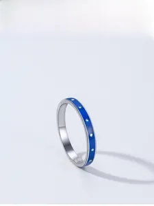 Macro view of S925 sterling silver ring with blue enamel and white polka dot design