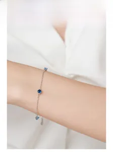 Close-up of elegant S925 silver bracelet with blue gemstones on female wrist