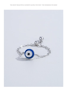 Detailed close-up of 925 sterling silver chain ring with blue enamel evil eye charm