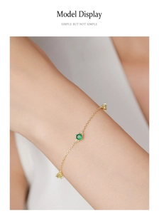 Close-up of 925 silver bracelet with green and yellow round zircon gemstones