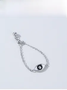Detailed macro view of 925 silver adjustable chain ring with evil eye charm