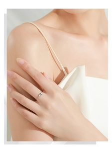 Detail of 925 sterling silver evil eye chain ring worn on a finger for an elegant look
