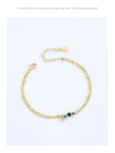 Detail of gold-plated silver double-layer bracelet with blue zircon stones and S925 tag