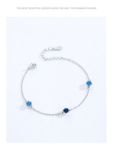Detailed shot of S925 sterling silver chain bracelet with three round blue stones