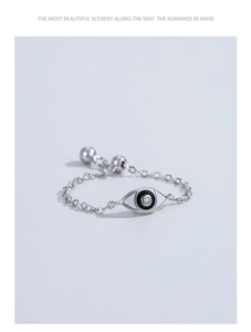 Close-up of adjustable 925 sterling silver chain ring with evil eye enamel charm