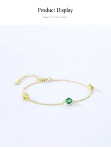 Detail view of 925 sterling silver gold bracelet with green and yellow cubic zirconia