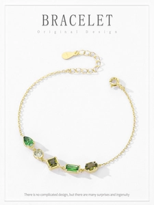 Detail of 925 sterling silver gold bracelet with multi-shaped green gemstones
