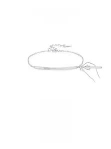 Detail of minimalist 925 silver bracelet featuring a sleek curved bar with inlaid zircons