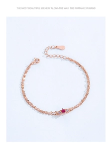 Detail of rose gold S925 sterling silver double-layer bracelet with red ruby and zircons