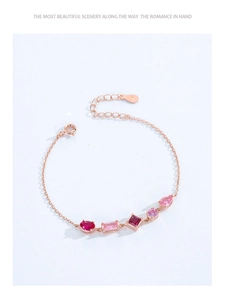 Detail of rose gold S925 silver bracelet featuring pink and red zircon gemstones