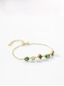 Detailed shot of 925 silver gold bracelet with multi-shape green and white gemstones