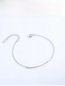 Detailed view of 925 sterling silver smile bar bracelet with pavé diamonds and heart charm