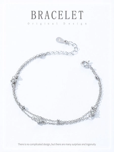 Macro detail of S925 sterling silver stamp and double-layered chain with zircon flowers