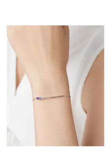 Detail of 925 sterling silver bracelet featuring colorful cubic zirconia on model wrist