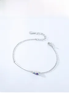 Macro detail of 925 sterling silver bracelet with three colored cubic zirconia stones