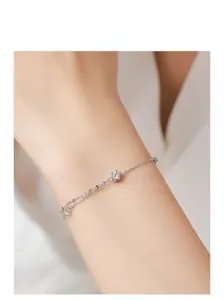 Close-up of elegant double-layered S925 silver chain bracelet with a sparkling cubic zirconia