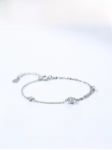 Macro detail of S925 sterling silver chain bracelet with three sparkling cubic zirconia