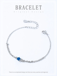 Détail macro de la chaîne en argent 925 avec zircon bleu et gravure du poinçon S925