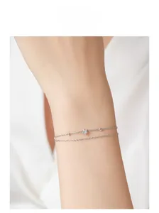 Close-up of a double-layer S925 sterling silver beaded bracelet on a woman's wrist