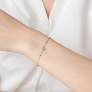 Elegant S925 sterling silver floral bracelet with cubic zirconia on a female wrist