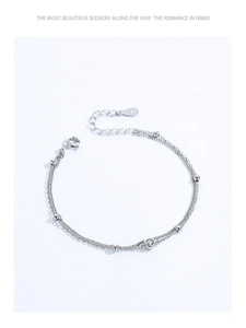 Macro detail of S925 sterling silver double-layer bracelet with beads and pavé zircon