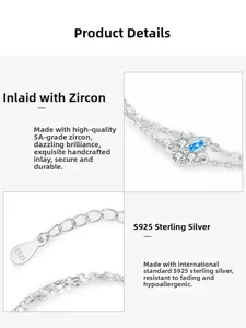 Macro detail of S925 silver bracelet with blue zircon drop and fine double chain