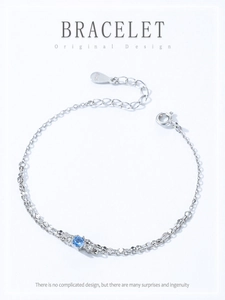 Macro detail of S925 sterling silver chain with icy blue zircon and lobster clasp