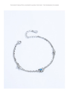 Macro shot of 925 sterling silver double-layer bracelet with blue flower-shaped gemstone