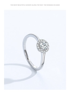 Macro shot of 925 silver halo ring featuring round zircon center stone and fine side gems