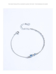 Macro shot of S925 sterling silver chain with light blue gemstones and lobster clasp