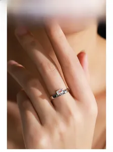 Close-up of minimalist S925 sterling silver ring with emerald-cut square zircon on finger