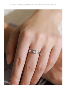 Macro shot of minimalist S925 sterling silver ring with oval zircon on female finger