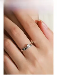 Close-up of a S925 sterling silver ring with a sparkling cubic zirconia stone on a finger