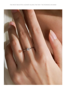 Close-up of a sparkling round-cut solitaire S925 silver ring on a woman's finger