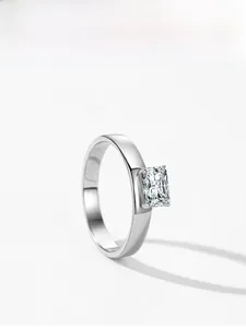 Macro shot of silver square emerald-cut cubic zirconia ring with polished metal finish